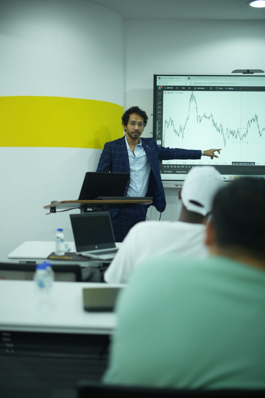Anas Merchant explaining a market chart during a training session
