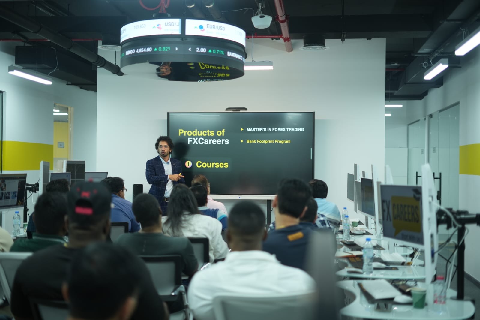 Anas Merchant presenting forex education to a classroom of students